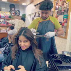 A client getting her caramel balayage. The process involves careful sectioning and application to create that seamless, natural-looking blend.