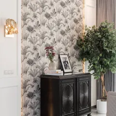 A beautiful corner where vintage meets modern. We paired an intricately carved black cabinet with an eclectic, tropical-print wallpaper, creating a look that is both timeless and full of personality.