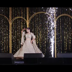 The bride shines during her solo sangeet performance. Her graceful twirl and the sparkling stage effects make for a magical and captivating photograph.