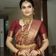 This full-length view displays how the makeup, hair, and traditional attire come together. The bride's posture exudes grace, and her makeup provides a radiant focal point.