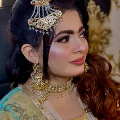 Another angle from the peacock feather shoot. The side-swept hair and intricate jhoomar add to the elegance of this creative look.