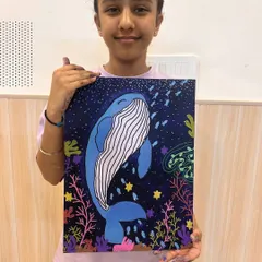 A proud artist with her finished whale painting. She did a wonderful job creating a magical underwater world filled with color and life.