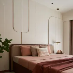 In this dusty rose bedroom, I used curved 3D cutouts on the wall to create subtle artwork. The 'less is more' philosophy is evident here, focusing on texture, soft colors, and a feeling of deep calm.