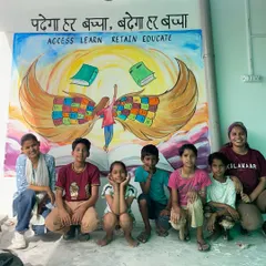 This mural, with the message 'पढ़ेगा हर बच्चा, बढ़ेगा हर बच्चा' (Every child will study, every child will progress), was created for a youth resource center in New Delhi. I worked with the children there to paint this vision of education giving them wings to fly. Posing with them in front of the finished piece was a moment full of hope.