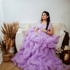 This stunning lavender ruffled gown is part of our extensive client wardrobe. Its voluminous design creates incredible texture and a high-fashion look, making it a perfect choice for a memorable studio portrait.