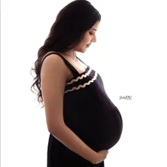 Another beautiful silhouette portrait. The mom-to-be is wearing a simple black dress, creating a timeless and elegant image that focuses on her and her baby bump.