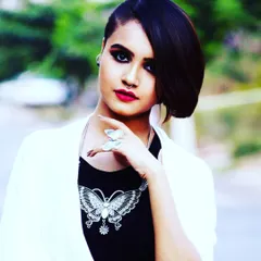 This is an example of an edgy, editorial makeup style for a fashion portfolio. I created a sharp, dark smokey eye and a classic red lip, paired with a modern asymmetrical haircut to deliver a bold and confident look.