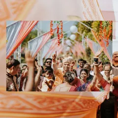 The groom's grand entrance! This photo captures the energy and excitement of the baraat, with the groom celebrating surrounded by his family and friends.