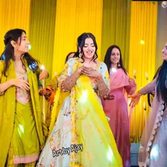 A candid shot of a bride dancing and enjoying her sangeet ceremony. Her beautiful mehndi is a part of her celebration, not something that holds her back.