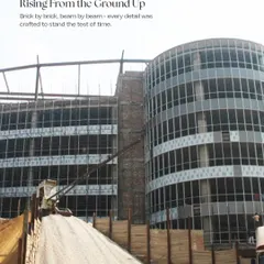 A photograph of the Infotech Centre during construction. This image captures the moment the structure was rising from the ground, showing the concrete and steel skeleton that would soon be clad in its iconic glass facade.