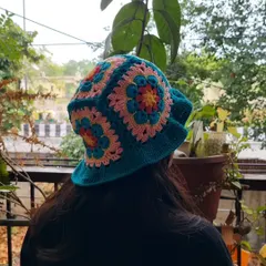 A view of our crochet bucket hat from the back, showing how the colorful granny squares are joined together to create the crown.