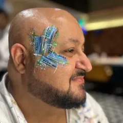 Yes, face painting is gender-neutral! This abstract design with blue and silver glitter looks so cool and modern.