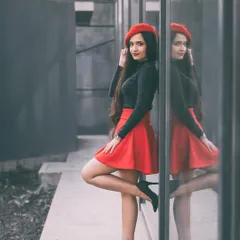 Capturing the chic 'Emily in Paris' vibe with a creative twist. I used a selective color technique to make the red skirt and beret pop against a monochrome background, highlighting the model's reflection for a stylish, modern portrait.