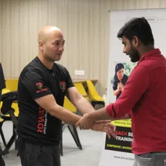 A close-up of me providing one-on-one instruction during a workshop. Personal attention is key to ensuring each participant understands the mechanics and feels confident in their ability to execute the technique.