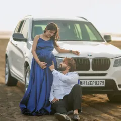 A modern and cool maternity shoot on the beach. Our simple yet elegant navy blue satin gown pairs perfectly with any casual or formal partner outfit.
