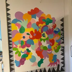 Here’s a look at the 'Freedom Mural' midway through. You can see how I layer shapes and colors, starting with big, bold forms and then filling them with intricate patterns. This layering process is what gives the final piece its depth.