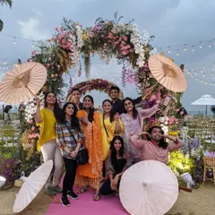 Our team on-site in sunny Phuket, posing before a beautiful beachside floral arch. From Jamnagar to Zanzibar, we go wherever your story takes us.