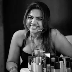 A smile of satisfaction after a successful session. Behind me is my kit, filled with the products I trust and teach you about, focusing on what works best for Indian skin tones and conditions.