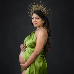A close-up portrait from the goddess shoot, showcasing the stunning headpiece and the confident expression of the expecting mother.