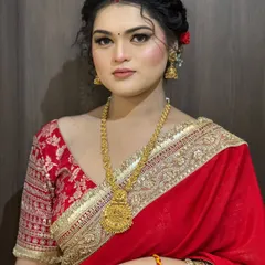 A full portrait of the client, looking poised and elegant in her traditional attire.