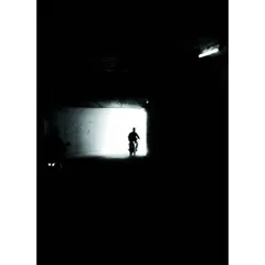 a silhouette of a biker at the end of a dark tunnel. i love playing with light and shadow, a technique that is central to creating effective dark mode interfaces.