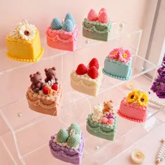 My collection of nine unique Birthday Cake candles displayed together. These are delightful and unexpected gifts, with designs featuring strawberries, teddy bears, and flowers.