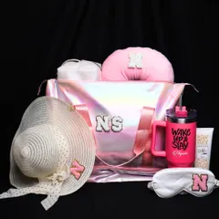 From gym runs to getaways, this iridescent duffle bag does it all. It's stylish, spacious, and can be personalized with initials, making it a perfect travel companion. The hamper also includes a matching hat, eye mask, and tumbler.