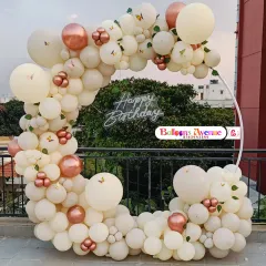Our decorations are perfect for any location, including this beautiful outdoor terrace setup in Bangalore. This features an elegant circular frame adorned with a dense arch of pastel and rose gold chrome balloons, butterfly accents, and a central 'Happy Birthday' neon sign, creating a perfect photo opportunity.