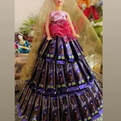 A fun and creative twist on a traditional tray. This doll's gown is made entirely of Dairy Milk chocolates, making it a perfect and delicious centerpiece for a birthday, engagement, or any sweet celebration.