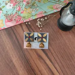 A beautiful grey version of my gotapatti jhumki earrings. The combination of the grey fabric, golden leaf motif, and red stone is truly elegant.