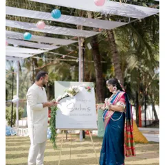 The happy couple arriving at their baby shower. This shot captures the scale of the outdoor venue and the festive atmosphere created by the decorations.