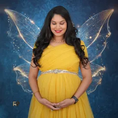 A moment of quiet reflection. This mom-to-be looks absolutely radiant in a yellow tulle gown, complemented by fantasy wings against a deep blue, starry backdrop. We can customize backdrops and effects to match your vision.