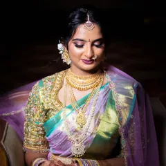 A vision in pastels. This bride chose a beautiful tissue silk saree in shades of lavender and seafoam green, paired with a heavily embellished blouse for her special day.