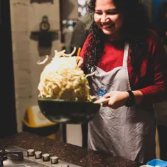 The joy of tossing noodles you've cooked yourself. This is a moment from our Chinese Cuisine Masterclass, where learning is always fun and interactive.