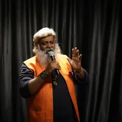 A storyteller captivates the audience at our open mic night. Our stage is a safe space for all forms of expression, from music and comedy to powerful spoken word and poetry.