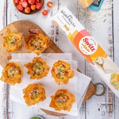 Savory filo cups for Switz, styled with fresh ingredients to suggest a recipe. This approach not only showcases the product but also inspires customers on how to use it, adding value beyond a simple product shot.