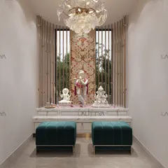 A beautiful blend of tradition and craftsmanship. This mandir design features a marble altar set against a window with a floral patterned backdrop, flanked by elegant metal screens. The space is completed with a stunning floral chandelier and deep teal poufs.