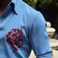 A detailed shot of the hand-painted motif on the chest and the quality of the shirt's fabric and construction.