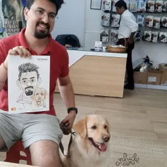 All smiles! A pet owner and his furry friend with their freshly drawn caricature.