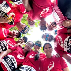 A fun team huddle, looking down at the camera. This unique angle captures the unity and playful spirit of our running group.