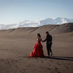 For this look, we wanted a bold pop of color. This stunning red Gauri & Nainika fit-and-flare gown was perfect for creating a grand, cinematic feel against the stark beauty of Iceland.