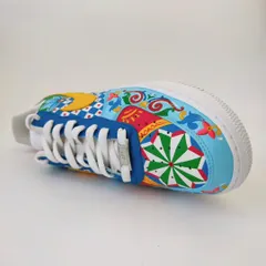 A top-down view of the maximalist Indian art sneakers. The design on the toe box is different for each shoe, one featuring a floral pattern and the other a geometric star, making them a true one-of-one pair.