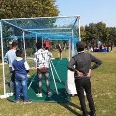 Guests enjoying the cricket bowling machine at an outdoor event. It's a safe and fun way to experience batting against a consistent bowler.