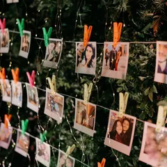 A memory wall for a cocktail night. We hung polaroid photos of the couple's journey on strings of fairy lights, creating a beautiful and personal decor element for guests to enjoy.