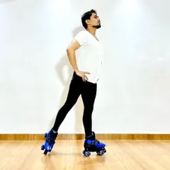Practicing a basic stance on roller skates, focusing on posture and control.