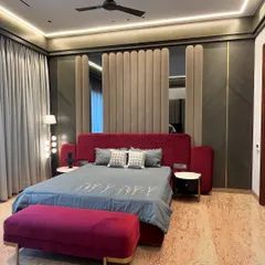 For this master bedroom in Ambala, we used a bold maroon and rich textures to create a space that feels both opulent and deeply personal. The custom upholstered wall panel behind the bed adds a layer of softness and grandeur.