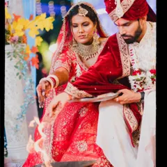The sacred Agni, witness to the couple's vows. This shot focuses on the bride and groom as they participate in the holy fire ritual, a cornerstone of the Hindu wedding ceremony.