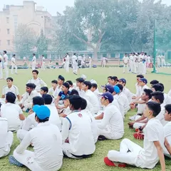 Addressing the team on the field. We instill discipline, mental toughness, and a deep understanding of the game's strategy in every session.