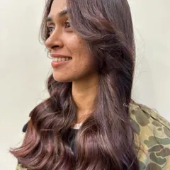 We call this look 'wine on brown'. We wove subtle crimson and wine-colored lowlights through a brunette base for a hint of color that adds richness and depth without being overpowering.