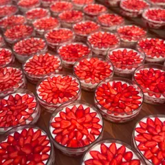 Layers of happiness, delivered. This is a large order of our Strawberry & Cream Cheese Trifles, each cup topped with beautifully arranged fresh strawberries. The vibrant red makes for a stunning visual.